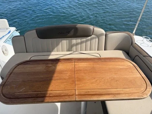 Bella Vida Yacht Photos Pics 2014 Sea Ray 310 Sundancer boat with wooden table and cushioned seating.