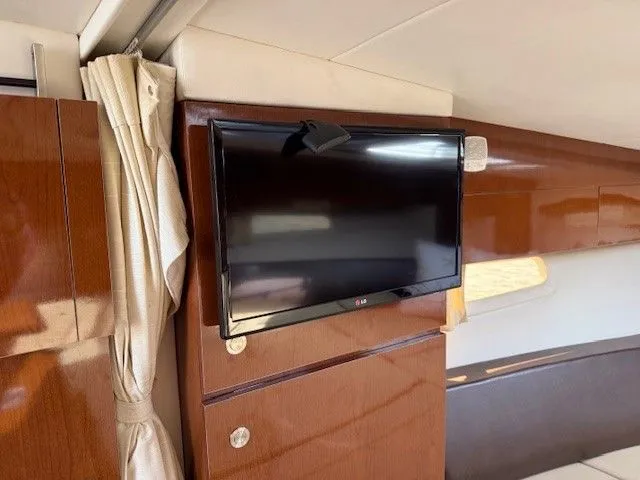 Bella Vida Yacht Photos Pics Interior of 2014 Sea Ray 310 Sundancer with mounted flat-screen TV.