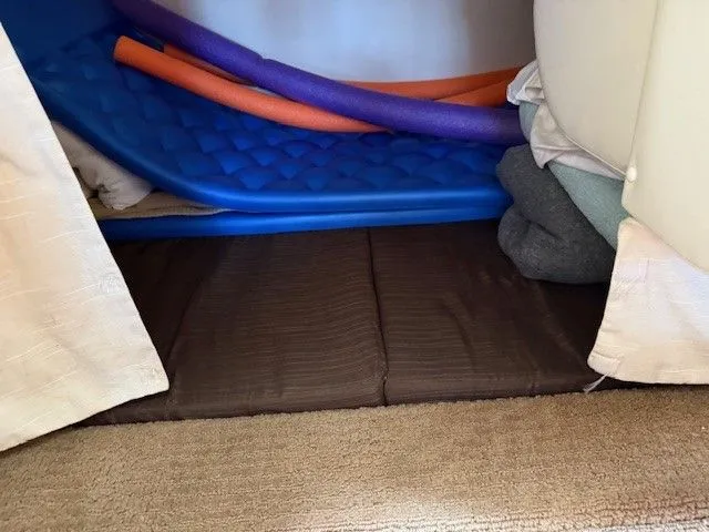 Bella Vida Yacht Photos Pics Storage area in a 2014 Sea Ray 310 Sundancer with pool noodles and cushions.