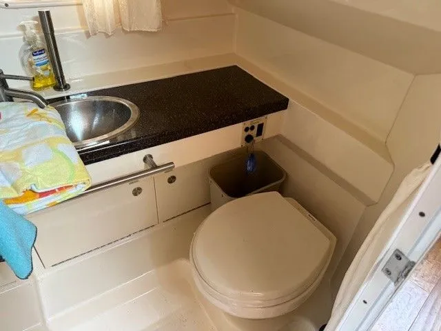 Bella Vida Yacht Photos Pics 2014 Sea Ray 310 Sundancer bathroom with sink, countertop, and toilet.
