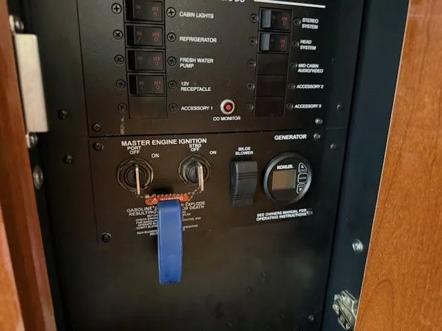 Bella Vida Yacht Photos Pics Control panel of a 2014 Sea Ray 310 Sundancer boat, featuring engine ignition and generator switches.