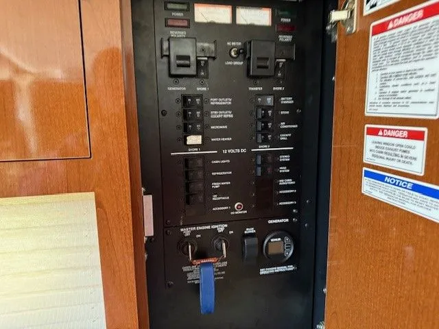 Bella Vida Yacht Photos Pics Electrical panel of 2014 Sea Ray 310 Sundancer boat with switches and labels.