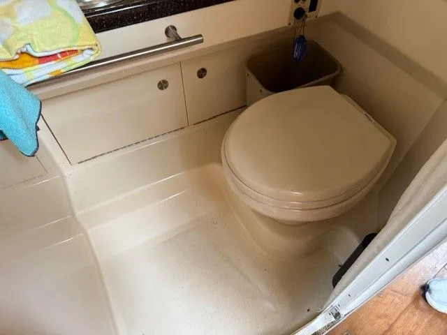 Bella Vida Yacht Photos Pics Bathroom interior of a 2014 Sea Ray 310 Sundancer boat, featuring a compact toilet.