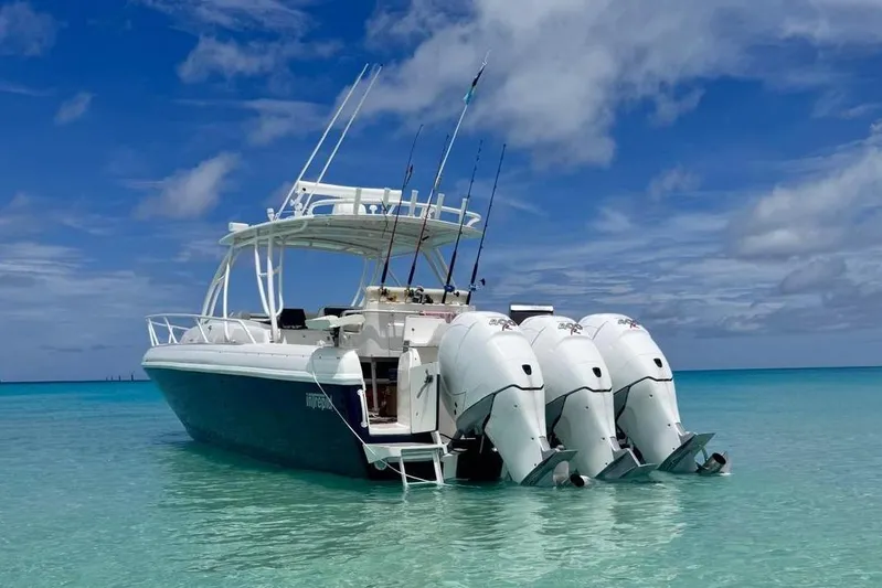  Yacht Photos Pics 2006 Intrepid 377 Walkaround boat in clear turquoise water under a blue sky.