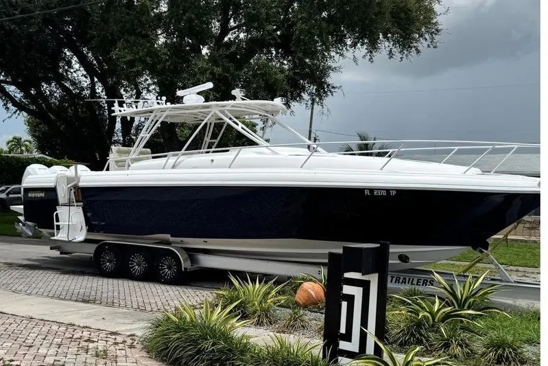  Yacht Photos Pics 2006 Intrepid 377 Walkaround boat on trailer, parked on brick driveway.
