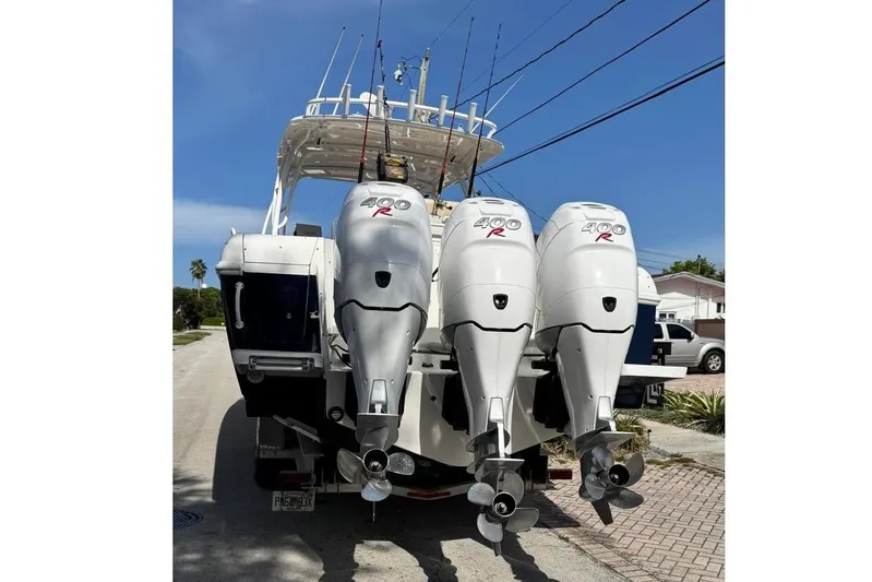  Yacht Photos Pics 2006 Intrepid 377 Walkaround boat with triple outboard engines on a sunny day.