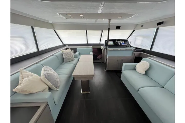  Yacht Photos Pics Luxurious interior of 2024 Fountaine Pajot MY 44 yacht with modern seating and helm station.