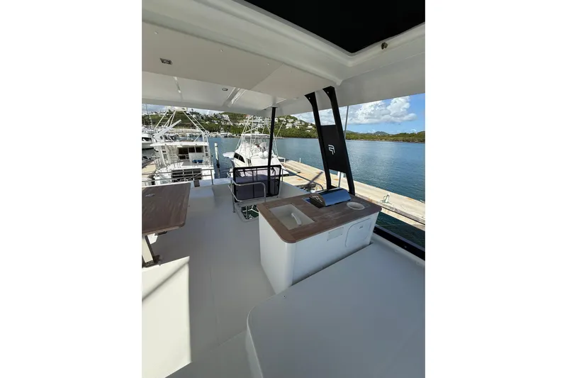  Yacht Photos Pics 2024 Fountaine Pajot MY 44 yacht interior with scenic marina view.