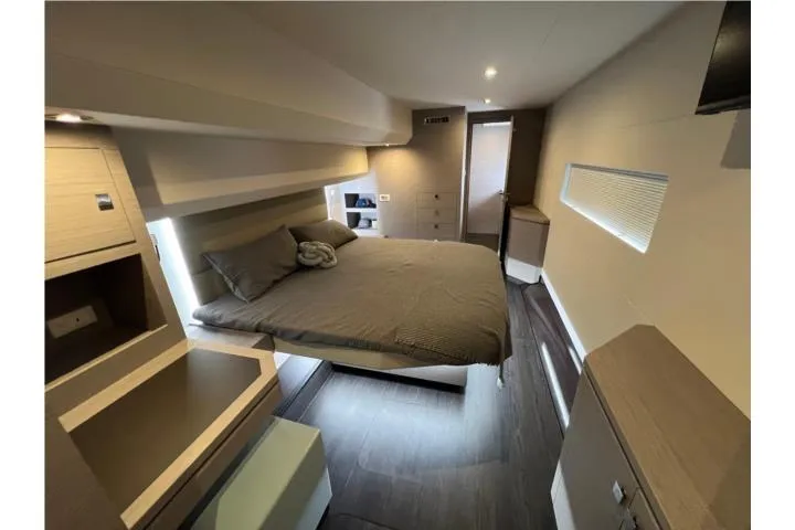  Yacht Photos Pics Luxurious bedroom interior of 2024 Fountaine Pajot MY 44 yacht, featuring modern design and cozy ambiance.