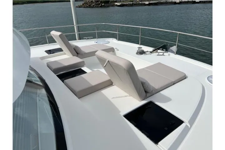  Yacht Photos Pics Luxury sun loungers on 2024 Fountaine Pajot MY 44 yacht deck, overlooking serene waters.