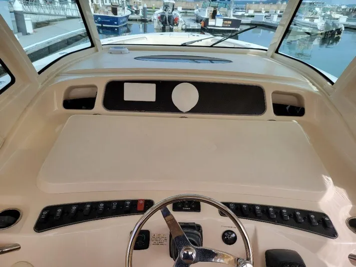  Yacht Photos Pics 2017 Grady-White 376 Canyon helm station with steering wheel and control panel.