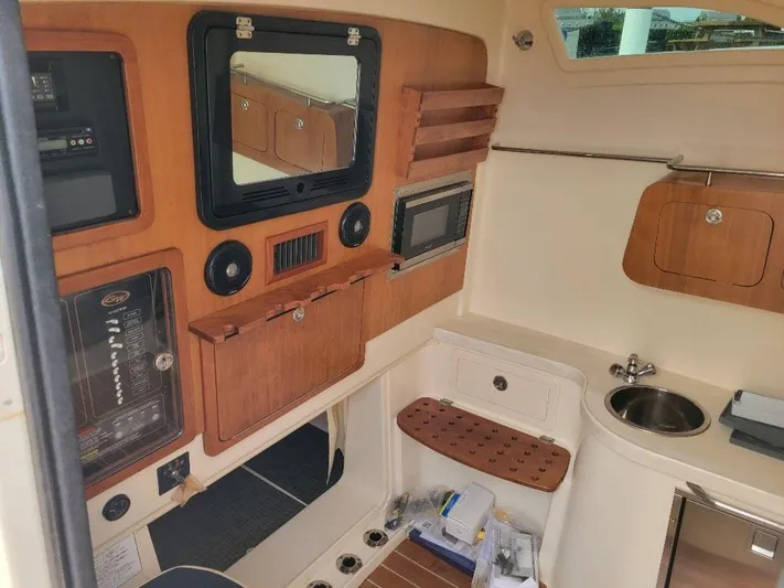  Yacht Photos Pics 2017 Grady-White 376 Canyon boat interior with control panel, sink, and storage.