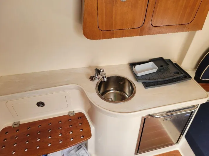  Yacht Photos Pics 2017 Grady-White 376 Canyon boat interior with sink, storage, and mini-fridge.