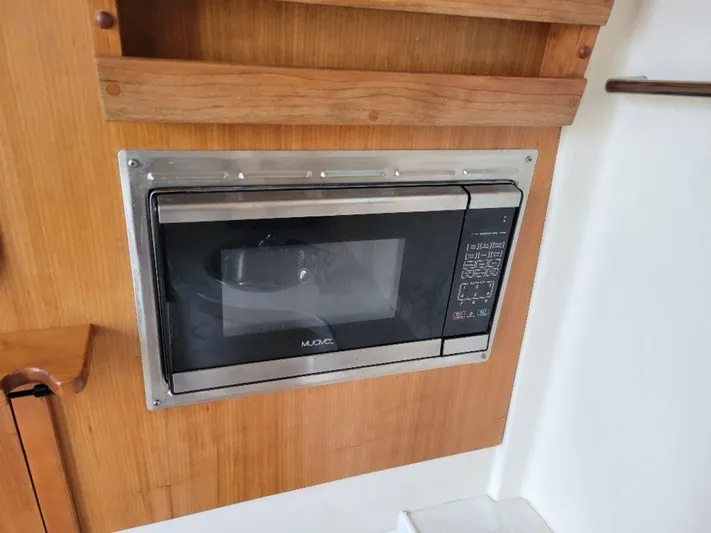  Yacht Photos Pics Built-in microwave in 2017 Grady-White 376 Canyon boat kitchen.
