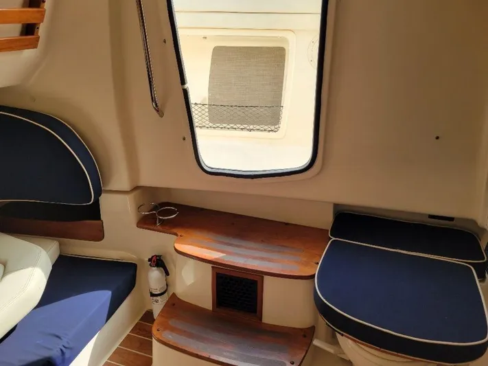  Yacht Photos Pics Interior cabin of 2017 Grady-White 376 Canyon boat with seating and wooden steps.