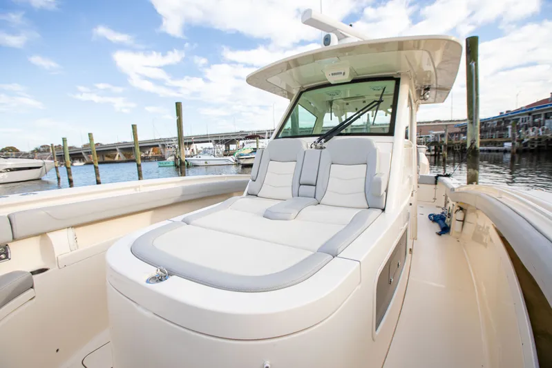  Yacht Photos Pics 2019 Scout 355 LXF boat with luxurious seating at a marina.