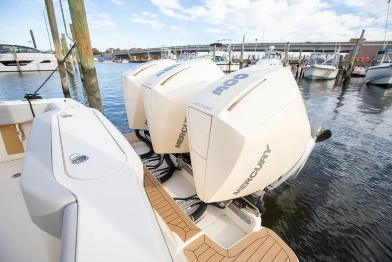  Yacht Photos Pics 2019 Scout 355 LXF boat with triple Mercury outboard engines docked at marina.