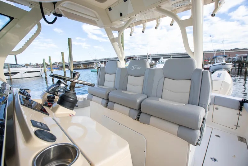  Yacht Photos Pics 2019 Scout 355 LXF boat interior with luxurious seating and helm, docked at marina.