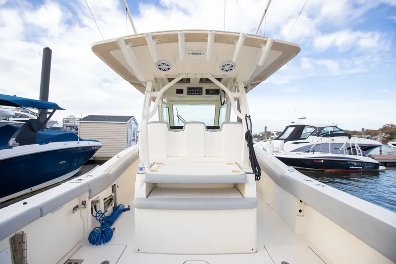  Yacht Photos Pics 2019 Scout 355 LXF boat interior with seating, docked at marina.