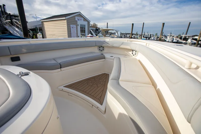  Yacht Photos Pics Luxurious seating area on a 2019 Scout 355 LXF boat, docked at a marina.