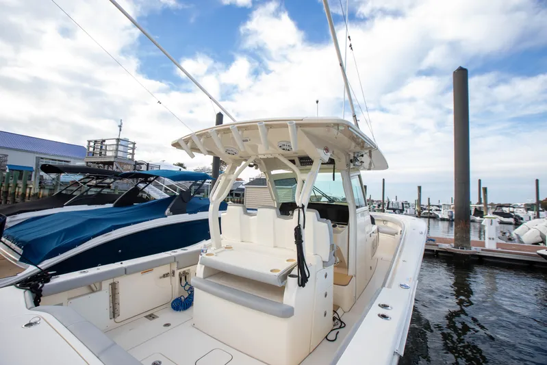  Yacht Photos Pics 2019 Scout 355 LXF boat docked at marina under cloudy sky.