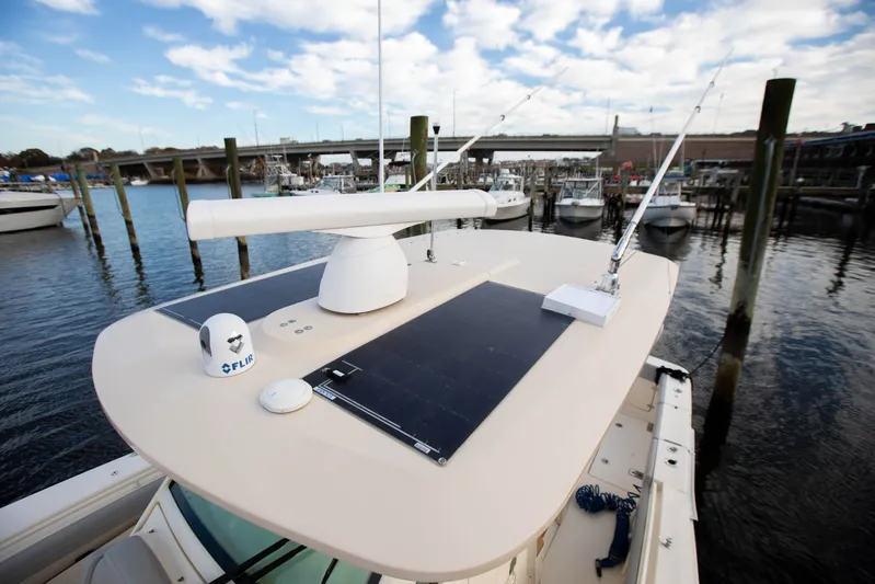  Yacht Photos Pics 2019 Scout 355 LXF boat with radar and solar panels docked at marina.