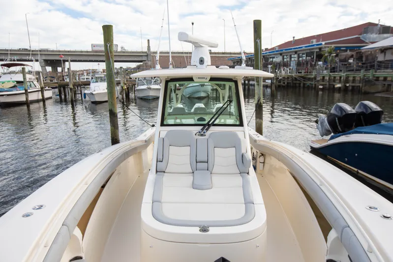  Yacht Photos Pics 2019 Scout 355 LXF boat docked at marina, featuring spacious seating and modern design.
