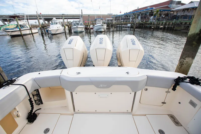  Yacht Photos Pics 2019 Scout 355 LXF boat with triple outboard engines docked at a marina.