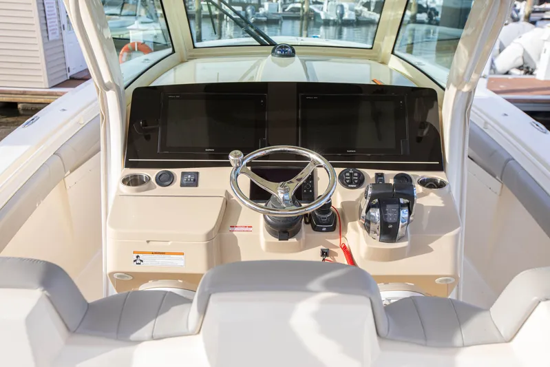  Yacht Photos Pics 2019 Scout 355 LXF boat helm with dual screens and steering wheel.