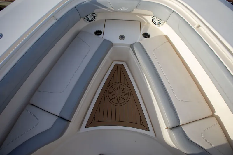  Yacht Photos Pics 2019 Scout 355 LXF boat interior with cushioned seating and compass design flooring.