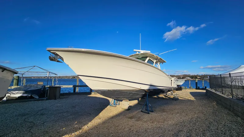  Yacht Photos Pics 2019 Scout 355 LXF boat on shore under sunny skies.
