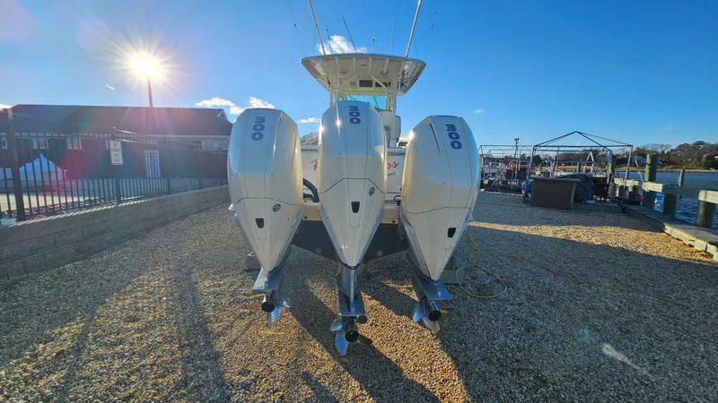  Yacht Photos Pics 2019 Scout 355 LXF with triple outboard engines outdoors.