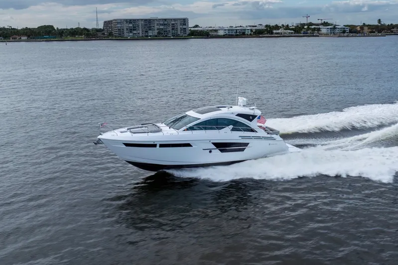 Tropical Dreamer Yacht Photos Pics 2022 Cruisers Yachts 54 Cantius cruising on open water, showcasing sleek design and performance.