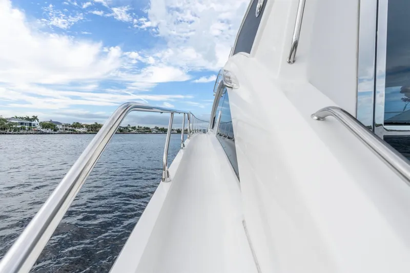Tropical Dreamer Yacht Photos Pics 2022 Cruisers Yachts 54 Cantius side view with ocean and sky background.