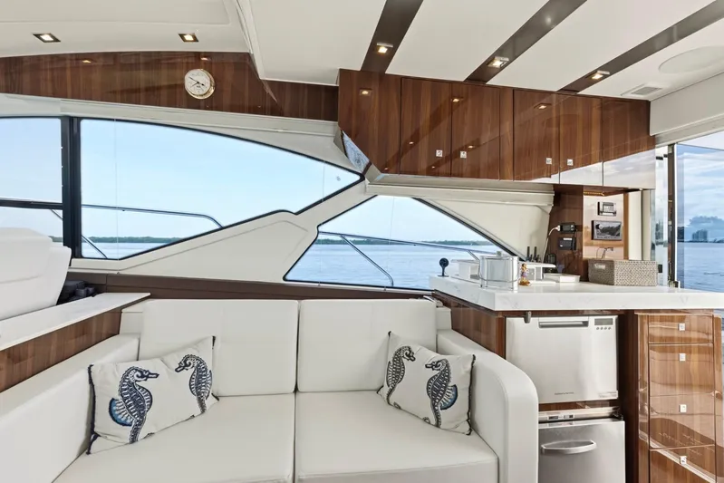 Tropical Dreamer Yacht Photos Pics Luxurious interior of 2022 Cruisers Yachts 54 Cantius with modern kitchen and elegant seating.