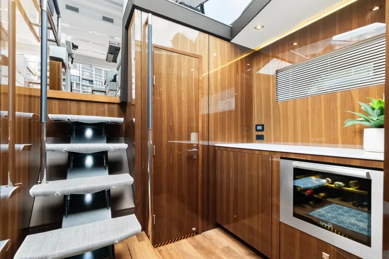 Tropical Dreamer Yacht Photos Pics Luxurious interior of 2022 Cruisers Yachts 54 Cantius with modern wood finish and wine cooler.
