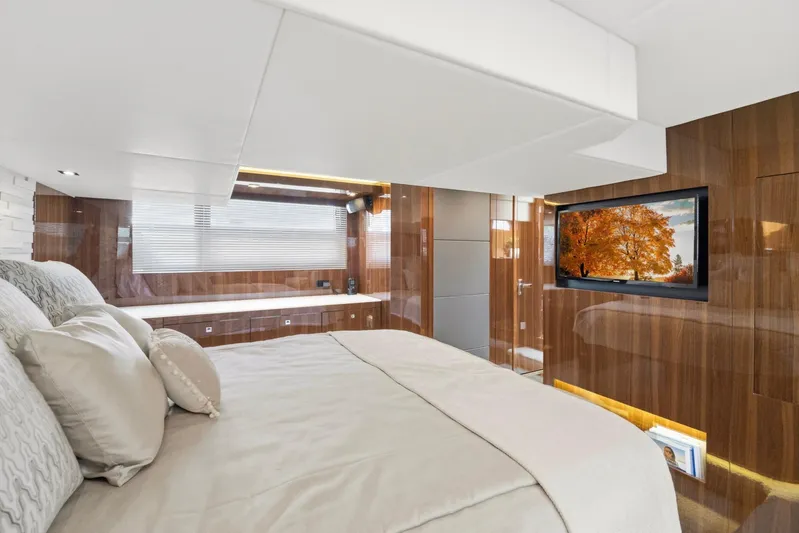 Tropical Dreamer Yacht Photos Pics Luxurious bedroom interior of 2022 Cruisers Yachts 54 Cantius with wood paneling and TV.