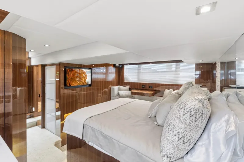 Tropical Dreamer Yacht Photos Pics Luxurious 2022 Cruisers Yachts 54 Cantius bedroom with elegant wood paneling and modern decor.