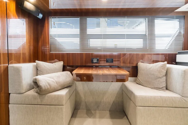 Tropical Dreamer Yacht Photos Pics Luxurious interior of 2022 Cruisers Yachts 54 Cantius with elegant seating and wooden accents.