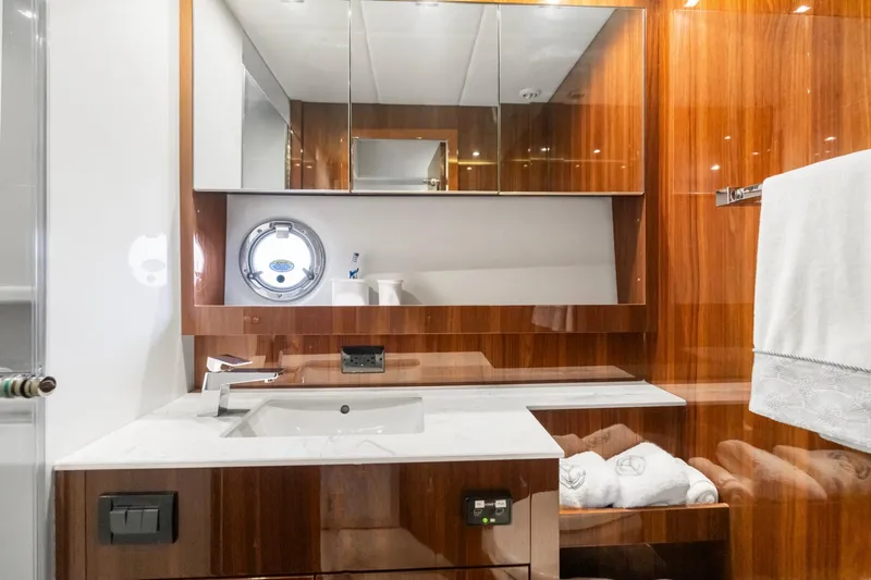 Tropical Dreamer Yacht Photos Pics Luxurious bathroom in 2022 Cruisers Yachts 54 Cantius with elegant wood finish and modern fixtures.