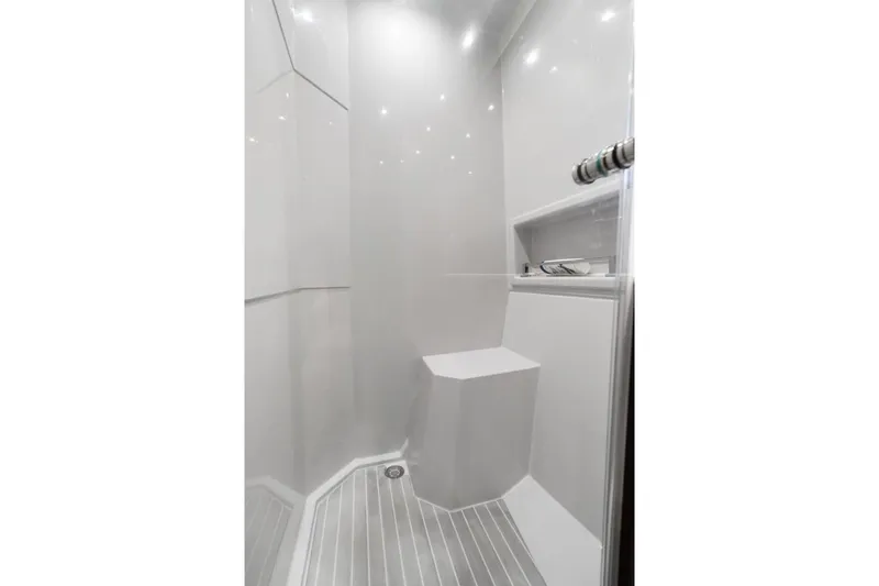 Tropical Dreamer Yacht Photos Pics Modern shower interior in 2022 Cruisers Yachts 54 Cantius, featuring sleek design and built-in seat.