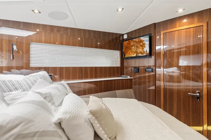 Tropical Dreamer Yacht Photos Pics Luxurious interior of 2022 Cruisers Yachts 54 Cantius with wood paneling and modern amenities.