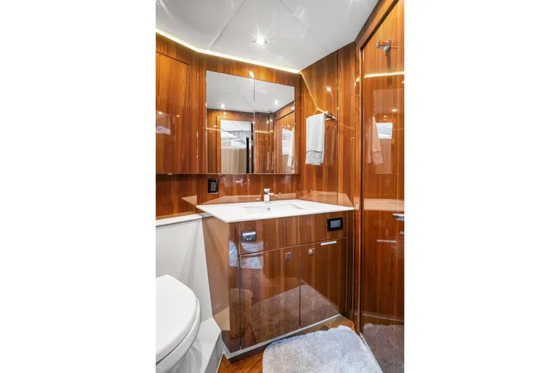 Tropical Dreamer Yacht Photos Pics Luxurious bathroom in 2022 Cruisers Yachts 54 Cantius with wood cabinetry and modern fixtures.