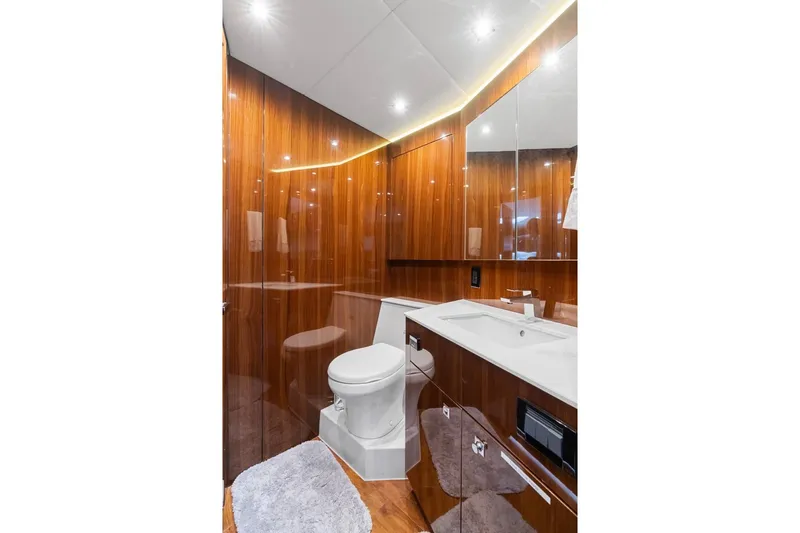 Tropical Dreamer Yacht Photos Pics Luxurious bathroom in 2022 Cruisers Yachts 54 Cantius with sleek wood paneling and modern fixtures.