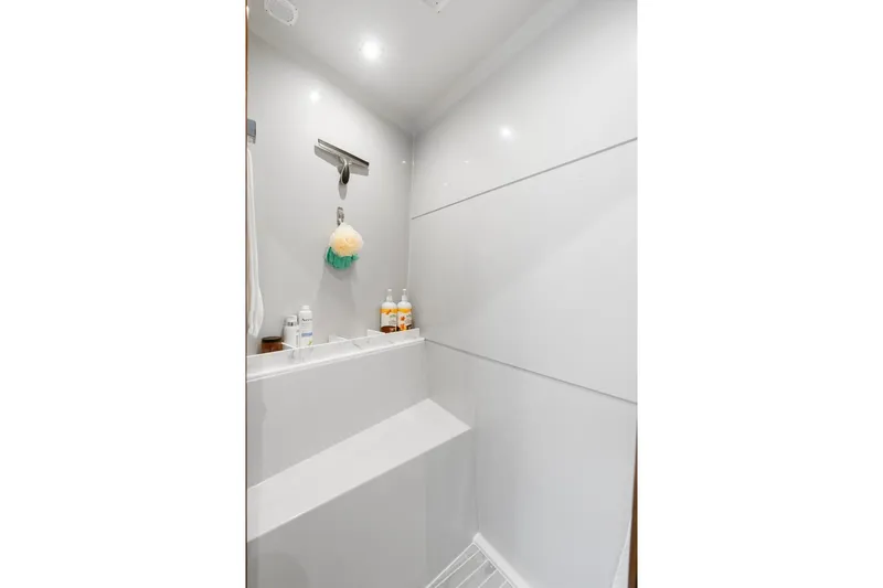 Tropical Dreamer Yacht Photos Pics Luxurious shower area in 2022 Cruisers Yachts 54 Cantius, featuring modern fixtures and amenities.