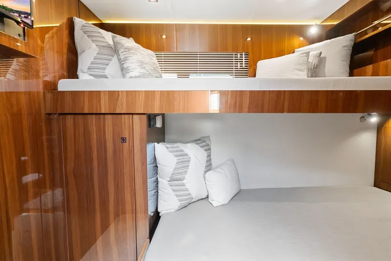 Tropical Dreamer Yacht Photos Pics 2022 Cruisers Yachts 54 Cantius interior with luxurious wooden bunk beds and modern lighting.