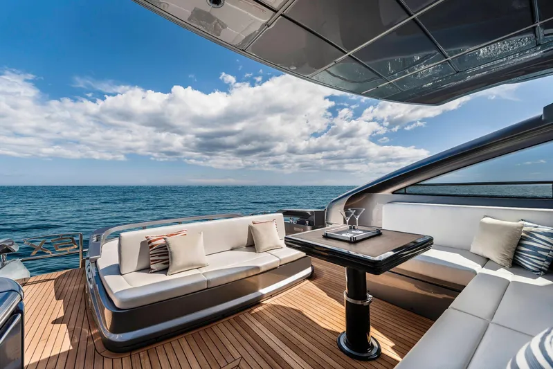  Yacht Photos Pics Luxurious 2025 Pershing 6X yacht deck with elegant seating and ocean view.