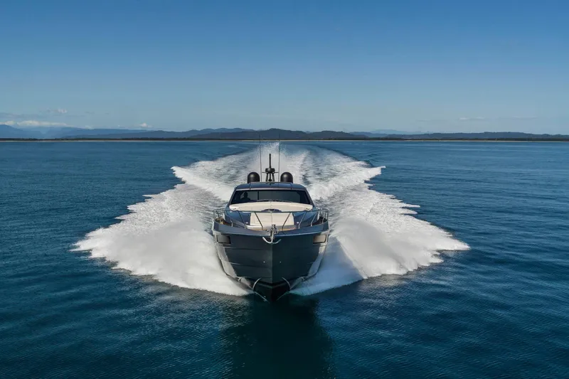  Yacht Photos Pics 2025 Pershing 6X yacht cruising on open water, creating a dynamic wake.