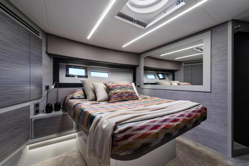  Yacht Photos Pics Luxurious bedroom interior of 2025 Pershing 6X yacht with modern design and cozy bedding.