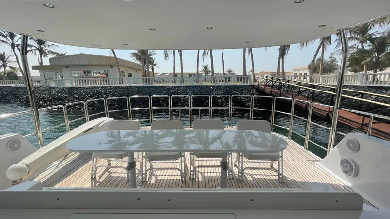 Spirit Yacht Photos Pics Outdoor dining area on 1999 Custom Austral Yachts Wavepiercer, featuring a sleek table and chairs.